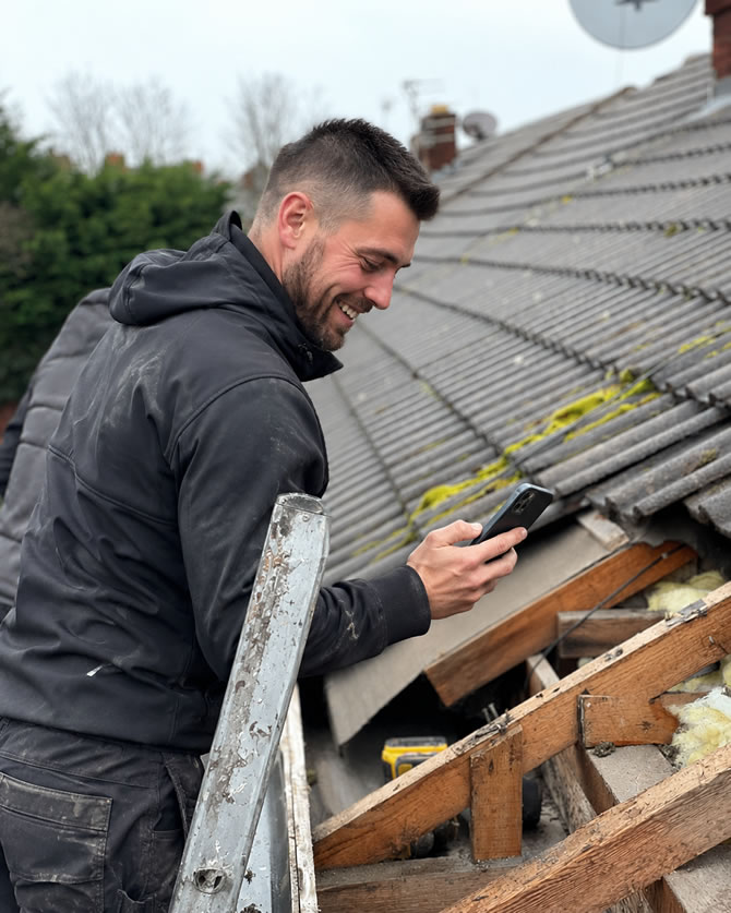 Roofer getting roofing job leads in his mobile app on phone
